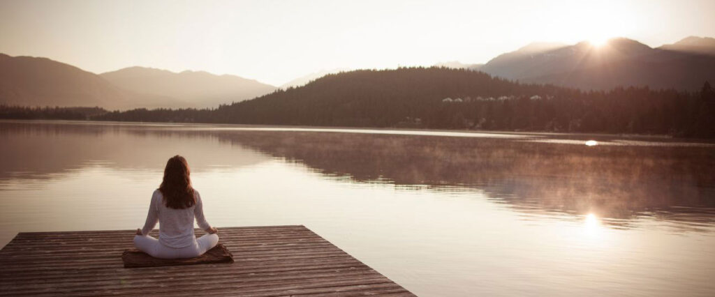 Image of peaceful woman meditating using a 5 minute morning meditation ritual for success.  Apply Ryan Zofay's 5-minute morning meditation guide for clarity and focus to level up your entire day.